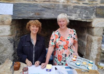 two helpers behind the cake stall
