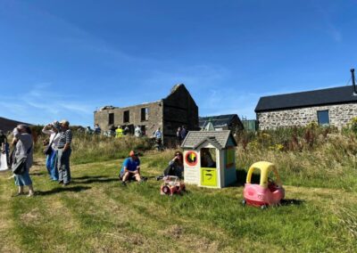 children's play area with a small Wendy house and car