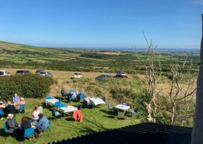People sitting down having a coffee or tea in the garden
