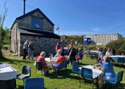 People sitting down having a coffee or tea in the garden