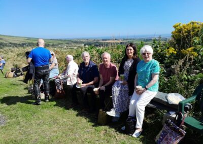 People sitting on a low wall in the garden