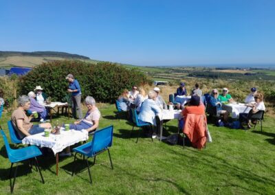 People sitting down having a coffee or tea in the garden