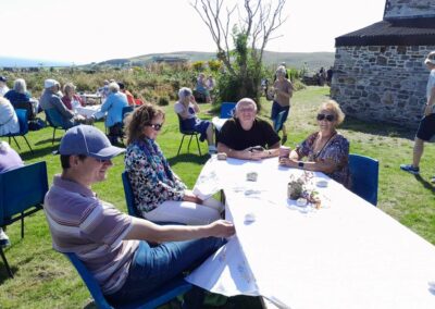 People sitting down having a coffee or tea in the garden