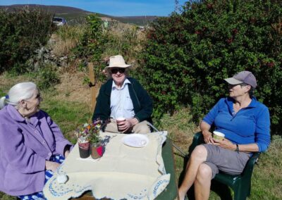People sitting down having a coffee or tea in the garden