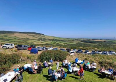 People sitting down having a coffee or tea in the garden